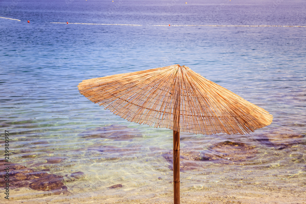 Sunshade and clear water on the beach, Lone Bay, Croatia