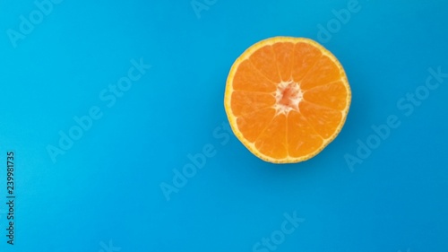 slice of orange on a blue background