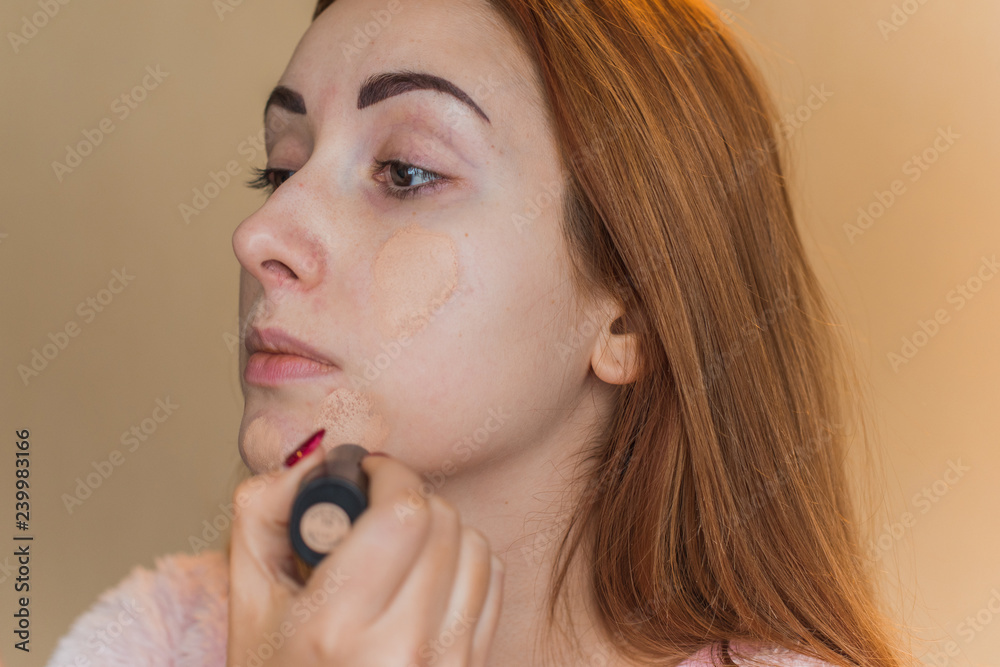 Girl take concealer on face, acne skin problem, face make up covered and Concept of skin problems Girl take concealer on face, acne skin problem, face make up covered and Concept of skin problems