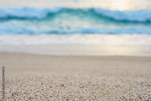  Sand on the beach close up with blurred sea and waves on a background on a sunset.