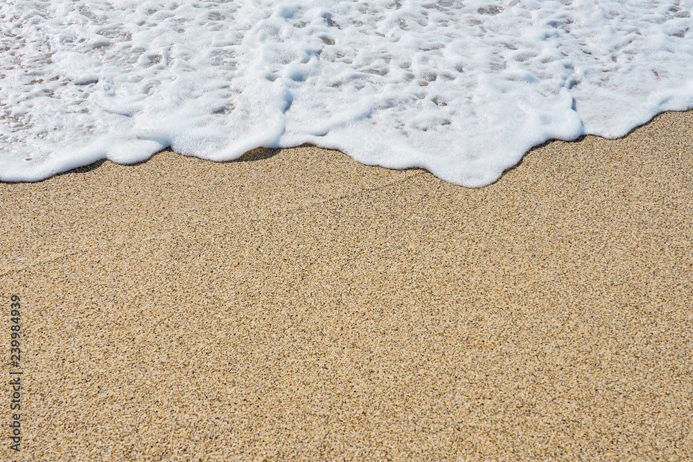 White foam on a sandy beach. Copy space. White foam on a sandy beach. Copy space.