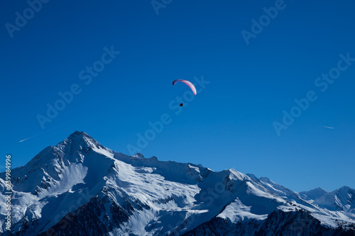 paragliding in the snow covered mountains