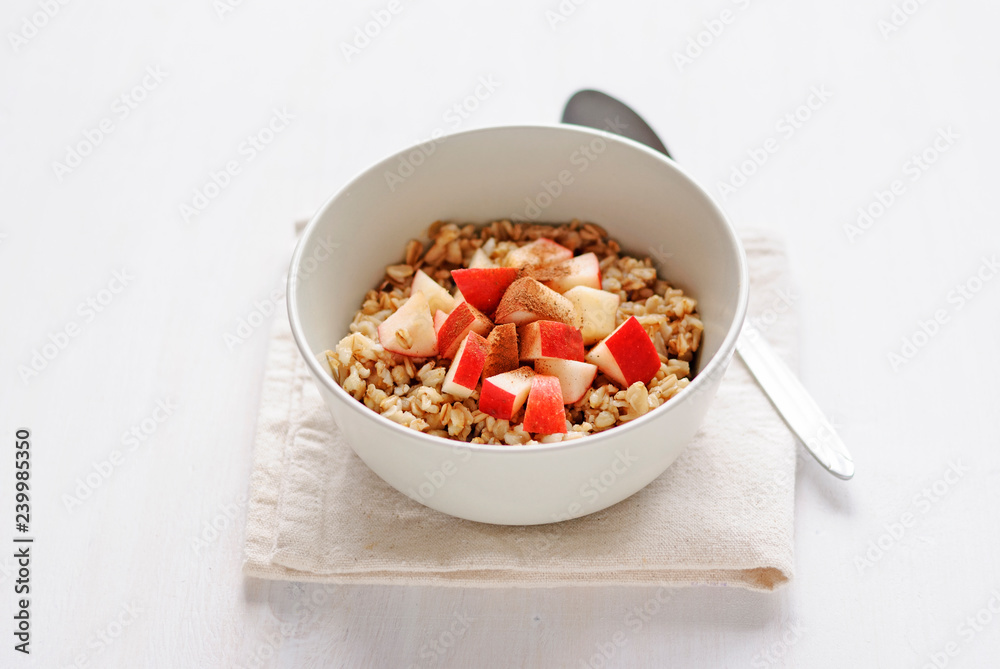Bowl of oatmeal with apple with the spoon Bowl of oatmeal with apple with the spoon