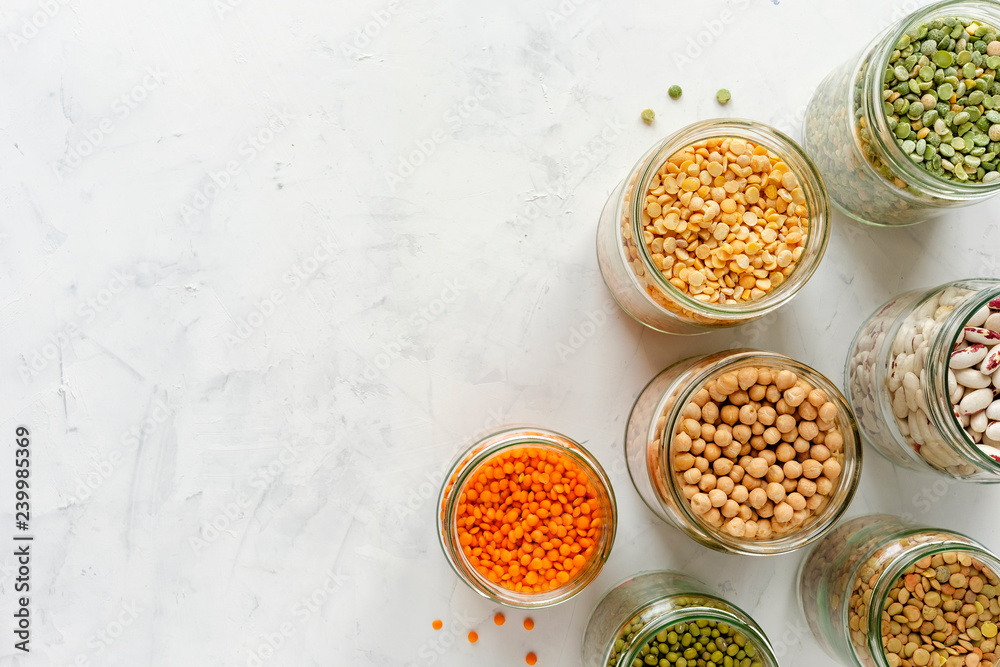 Colorful healthy dried legumes in glass jars Colorful healthy dried legumes in glass jars
