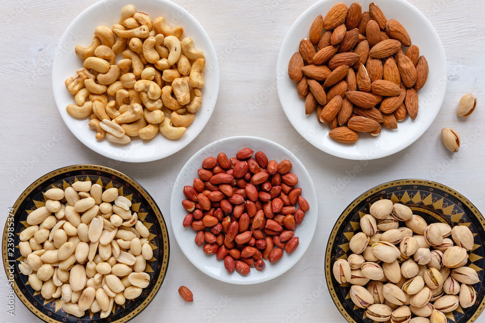 Assorted fresh nuts in bowls