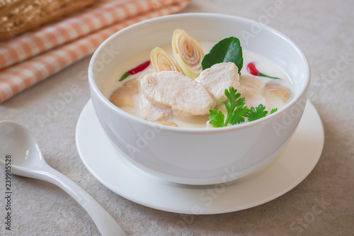 Chicken with coconut milk soup in white bowl, Thai food (Tom Kha Kai).