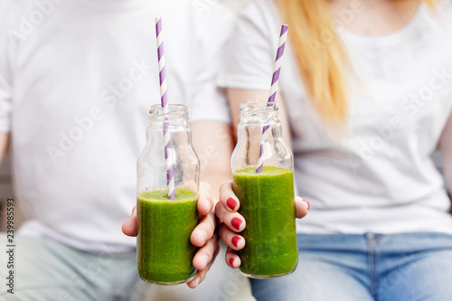 Young couple drinking green smoothie. Healthy life style concept.