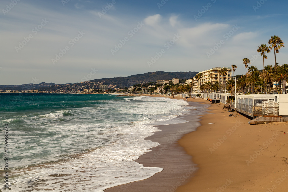 beach businesses in Cannes closed for the winter with waves onto the beach