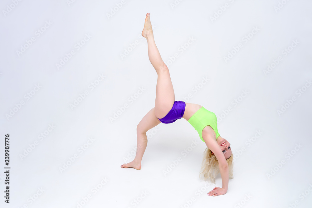 concept girl on a white background sitting on a twine in a dance suit