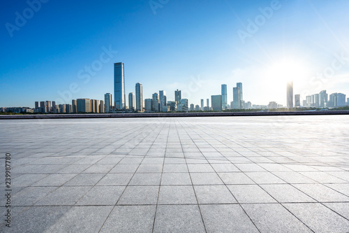 empty square with city skyline © THINK b