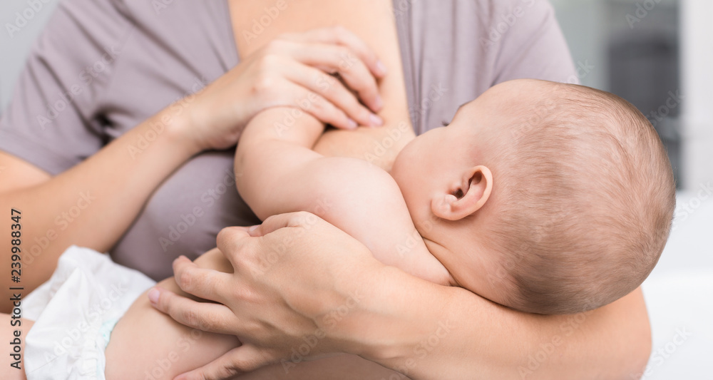 Young mom breast feeding her newborn child Young mom breast feeding her newborn child