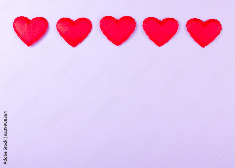 Red hearts, purple background, valentine's day decor. Top view. Copy space.