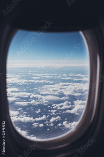 view of blue cloudy sky from airplane window