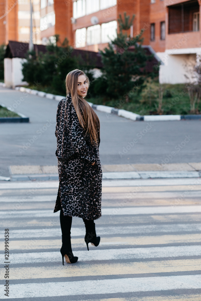 Beautiful stylish woman walking in the street, pedestrian crossing Beautiful stylish woman walking in the street, pedestrian crossing