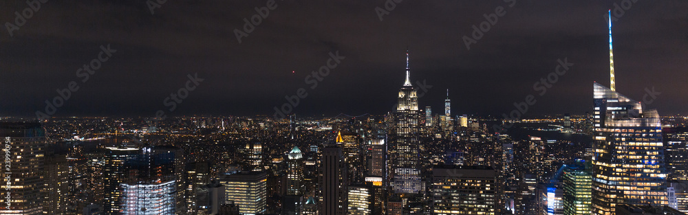 panoramic view of buildings and night city lights in new york, usa