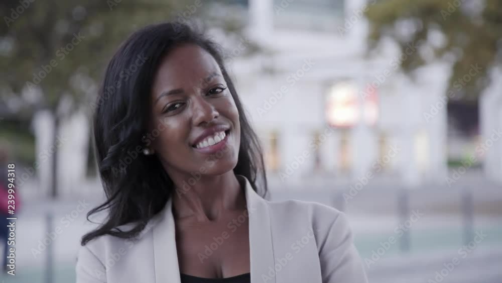 Smiling African American manager looking at camera. Portrait of successful female agent in white jacket. Success concept Smiling African American manager looking at camera. Portrait of successful female agent in white jacket. Success concept