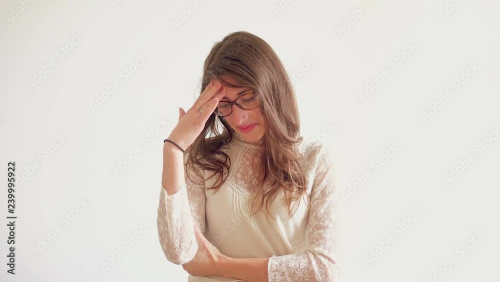 Upset young woman with headache. Tired girl holding hand on forehead. Illness concept Upset young woman with headache. Tired girl holding hand on forehead. Illness concept