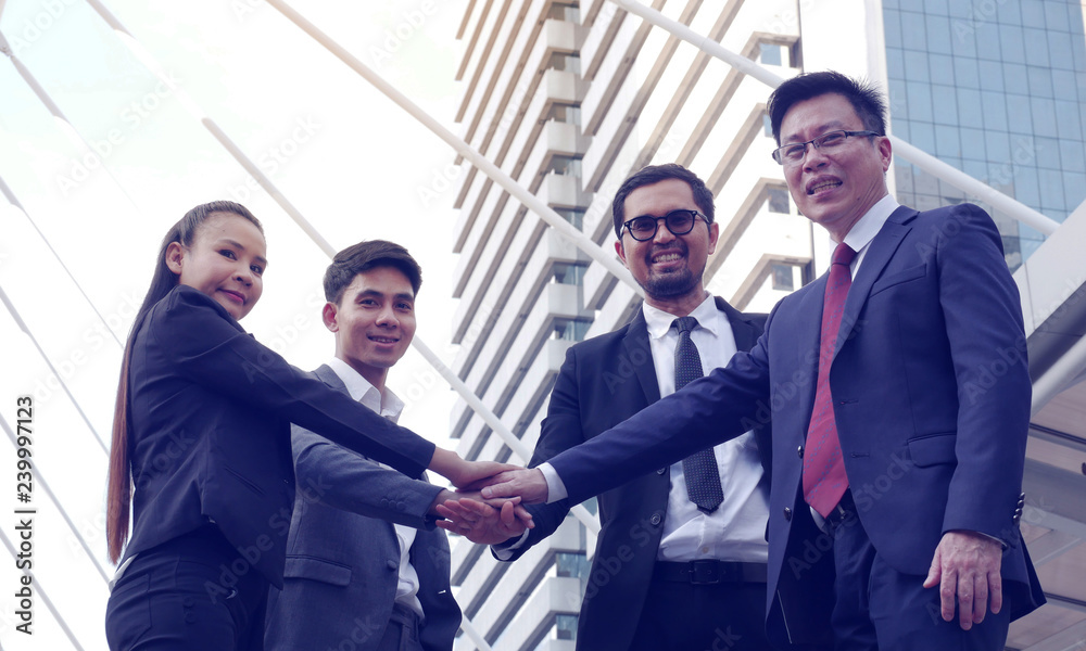 Business team showing unity with their hands together. Business team showing unity with their hands together.