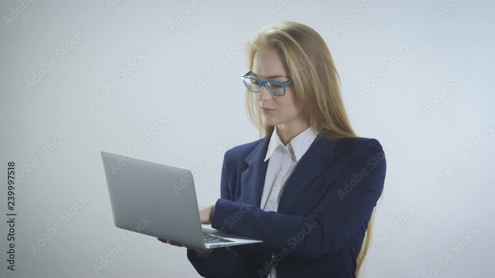 Young woman with laptop enjoys success on a white background Young woman with laptop enjoys success on a white background