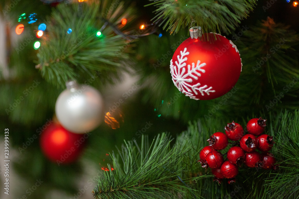 Christmas tree branch with colorful bauble isolated on blur background, festive border, New Year greeting card, magic night, glowing backdrop, xmas decoration, holiday ornament. Decorated fir tree Christmas tree branch with colorful bauble isolated on blur background, festive border, New Year greeting card, magic night, glowing backdrop, xmas decoration, holiday ornament. Decorated fir tree