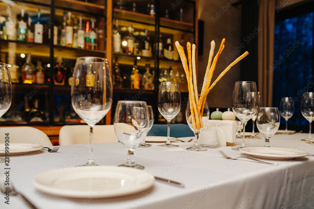 Wine glasses in a restaurant setting. Serving on the table. Crystal glasses for catering Wine glasses in a restaurant setting. Serving on the table. Crystal glasses for catering