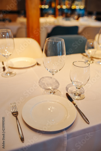 Wine glasses in a restaurant setting. Serving on the table. Crystal glasses for catering