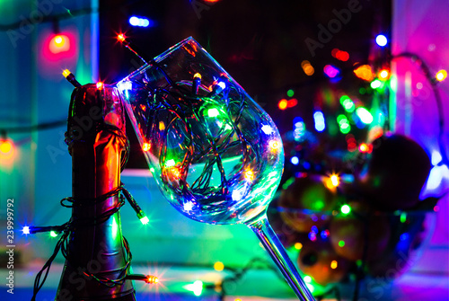 colored garland in a glass of champagne in the night the Windows in the run up to Christmas