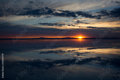 Sunrise over Salar de Uyuni, Bolivia, with water reflection