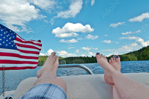 WIth a glimpse of the American flag, two people relax on a boat