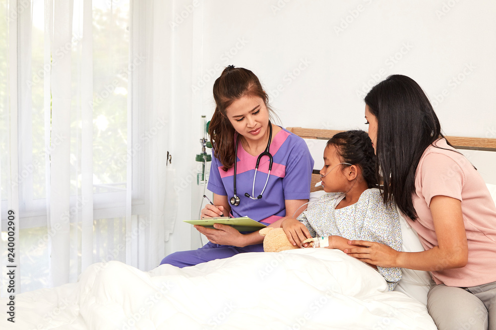 Doctor and child with mother in hospital