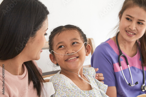 Doctor and child with mother in hospital