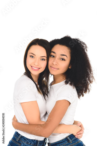 multicultural friends hugging and looking at camera isolated on white