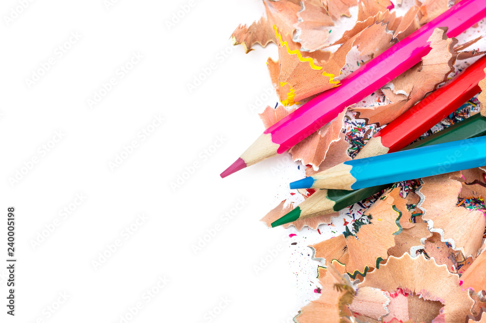 Colour pencils with colour shavings on white. Copy space. Colour pencils with colour shavings on white. Copy space.