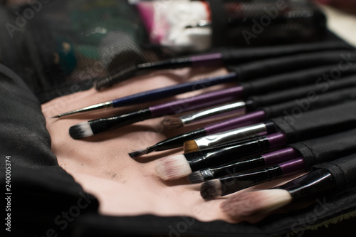 Professional makeup brushes set closeup near salon mirror