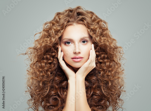 Woman with curly hair. Beautiful girl with healthy wavy hairstyle, haircare concept