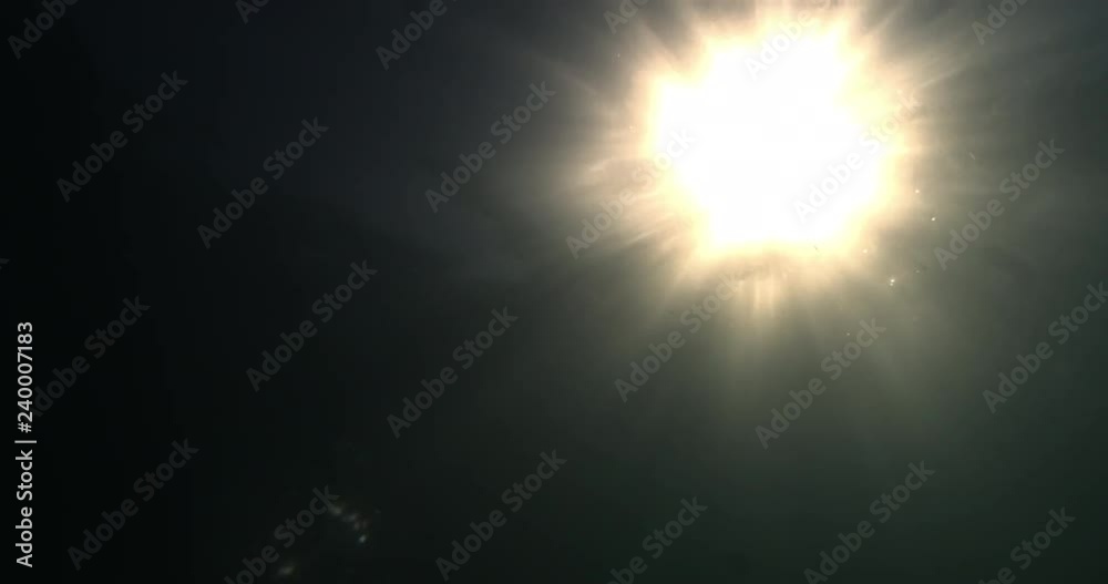 Beautiful underwater sea scene view with natural light rays, shining through the water's glittering and moving surface, caustics, bubbles, and foam. Beautiful underwater sea scene view with natural light rays, shining through the water's glittering and moving surface, caustics, bubbles, and foam.