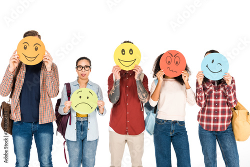 funny girl in glasses showing tongue near group of young people showing emotions on cards isolated on white