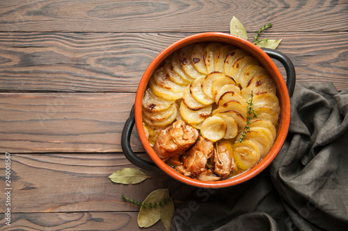 Homemade Lancashire hotpot - a stew  consists of lamb, onion, carrot, Worcestershire sauce, topped with sliced potatoes, bay leaves, thyme  and baked in a heavy pot on a low heat. photo