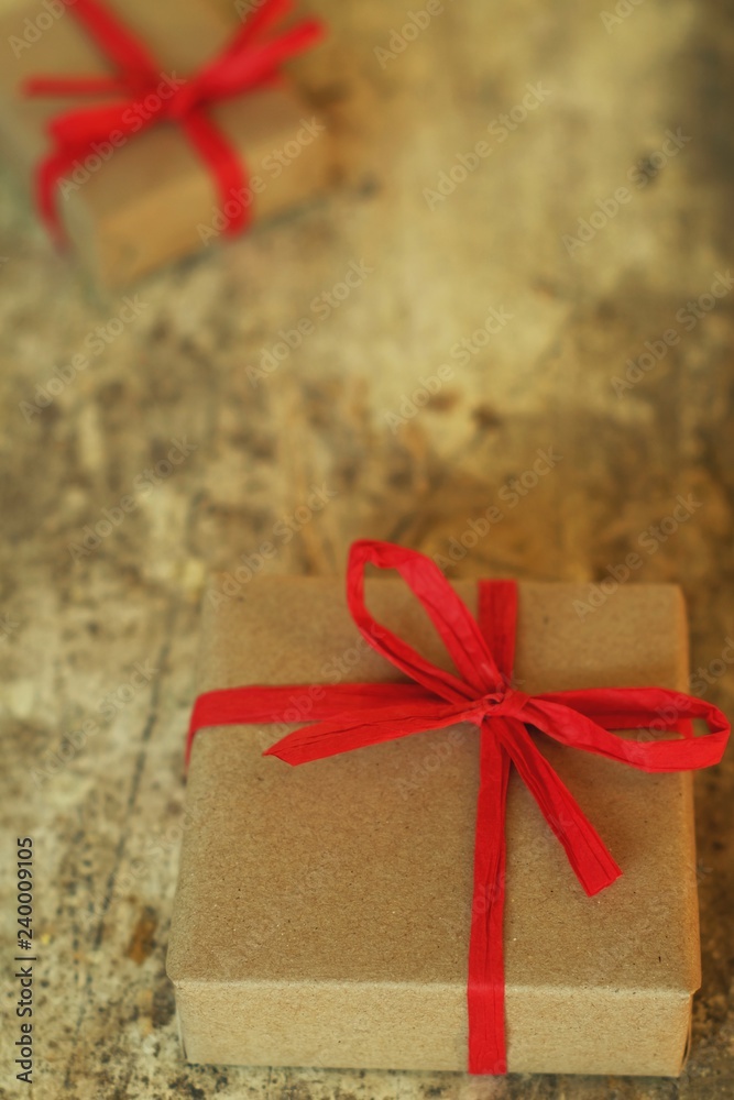 Simple eco friendly gift boxes package wrap with brown paper in old wooden table background, green present concept Simple eco friendly gift boxes package wrap with brown paper in old wooden table background, green present concept
