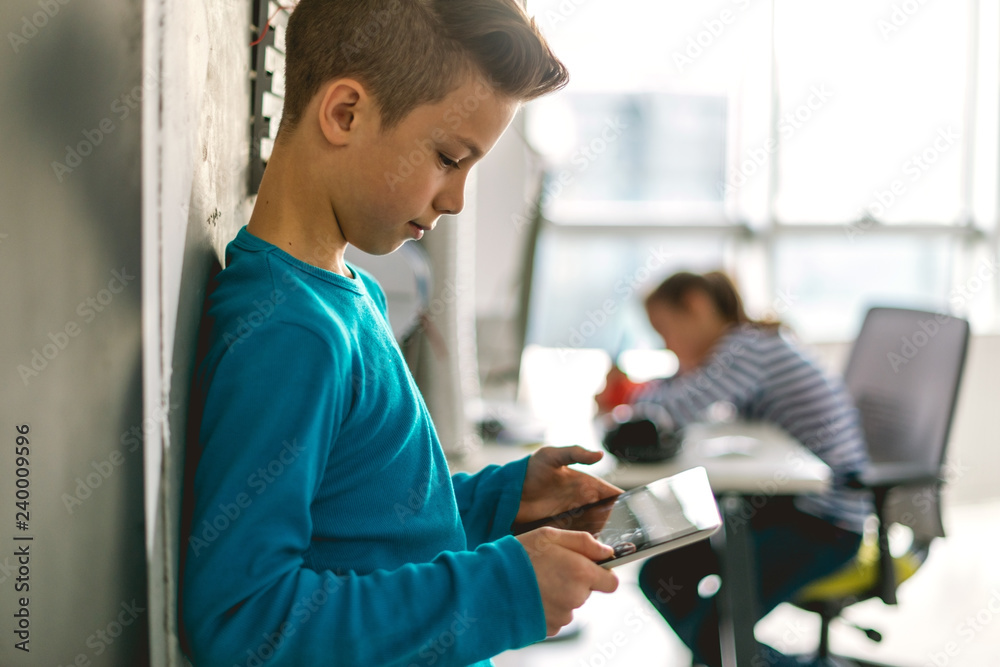 Teenage boy looking at digital tablet Teenage boy looking at digital tablet