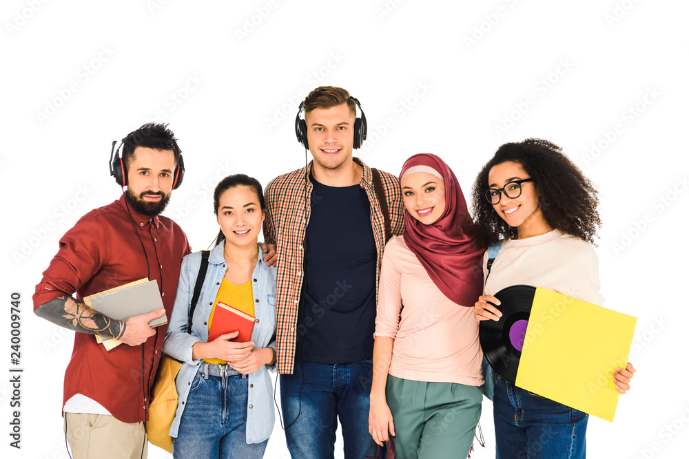 happy men standing in headphones and african american woman holding vinyl record near girls isolated on white