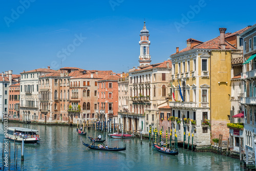 Traditional gondolas and touristic boat at the Grande Channel of Venice.