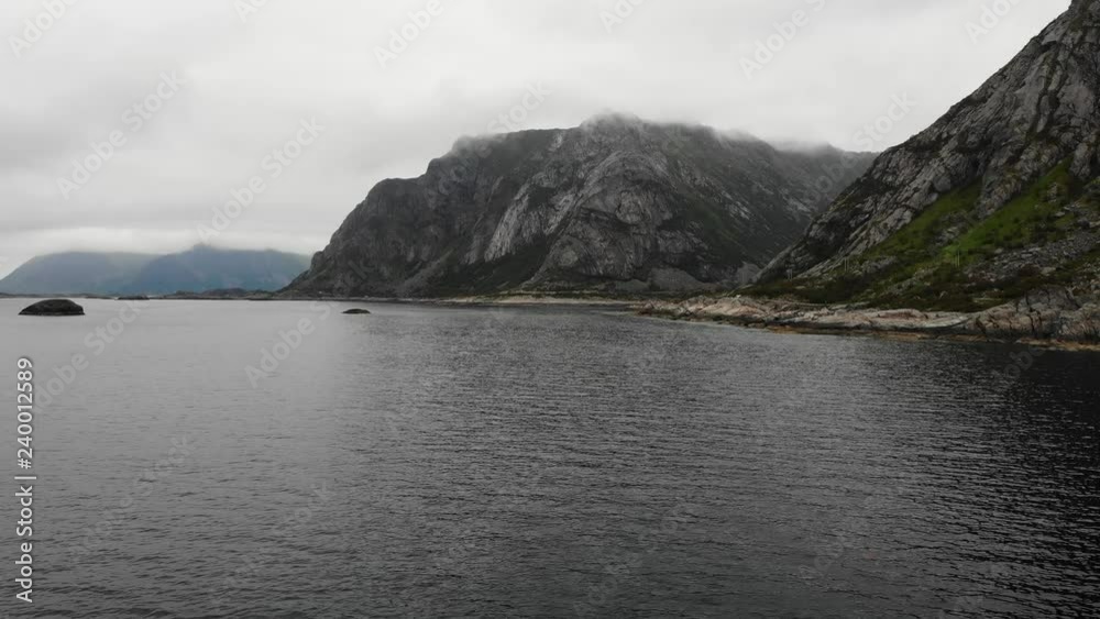 Fjord landscape. Lofoten islands in North Norway near Henningsvaer village. Hazy rainy day, overcast weather Fjord landscape. Lofoten islands in North Norway near Henningsvaer village. Hazy rainy day, overcast weather
