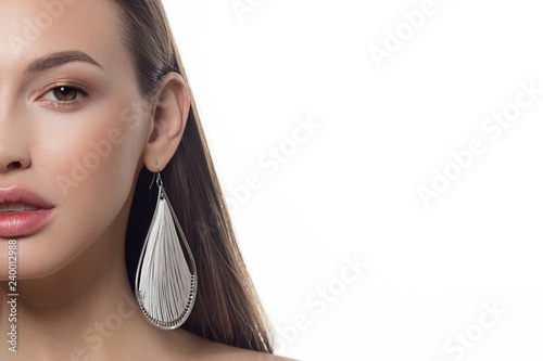 Sexual full lips. Natural gloss of lips and woman's skin. The mouth is closed. Increase in lips, cosmetology. Orange lips and long neck. Great summer mood with open eyes. fashion jewelry