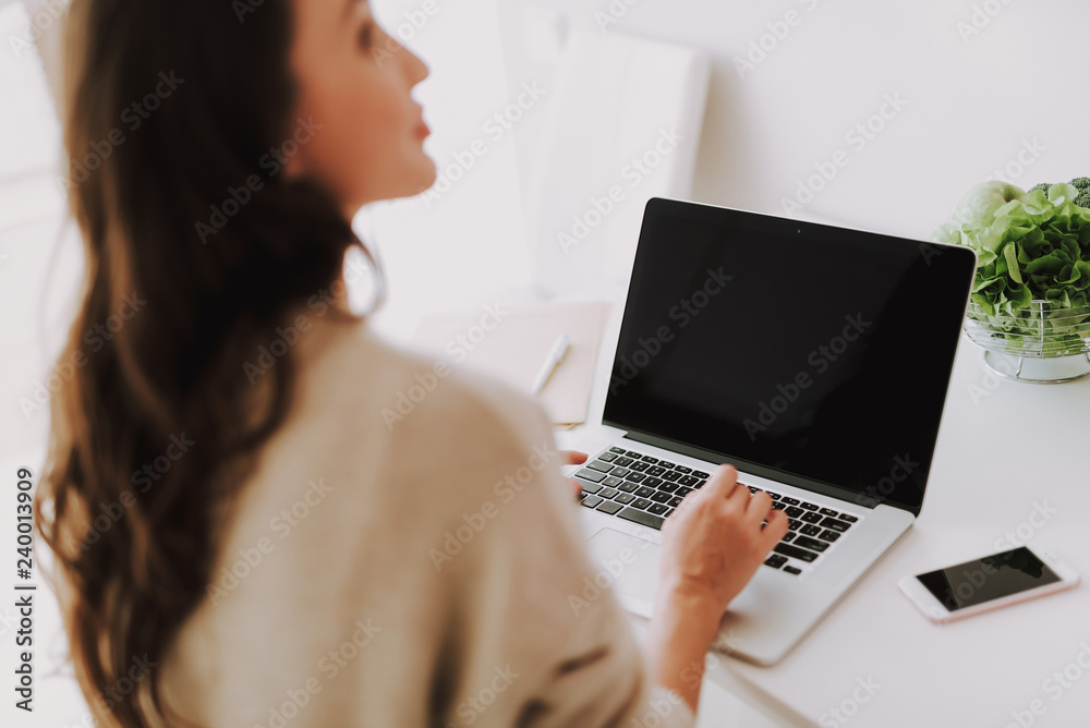 Young attractive woman working on notebook at house Young attractive woman working on notebook at house