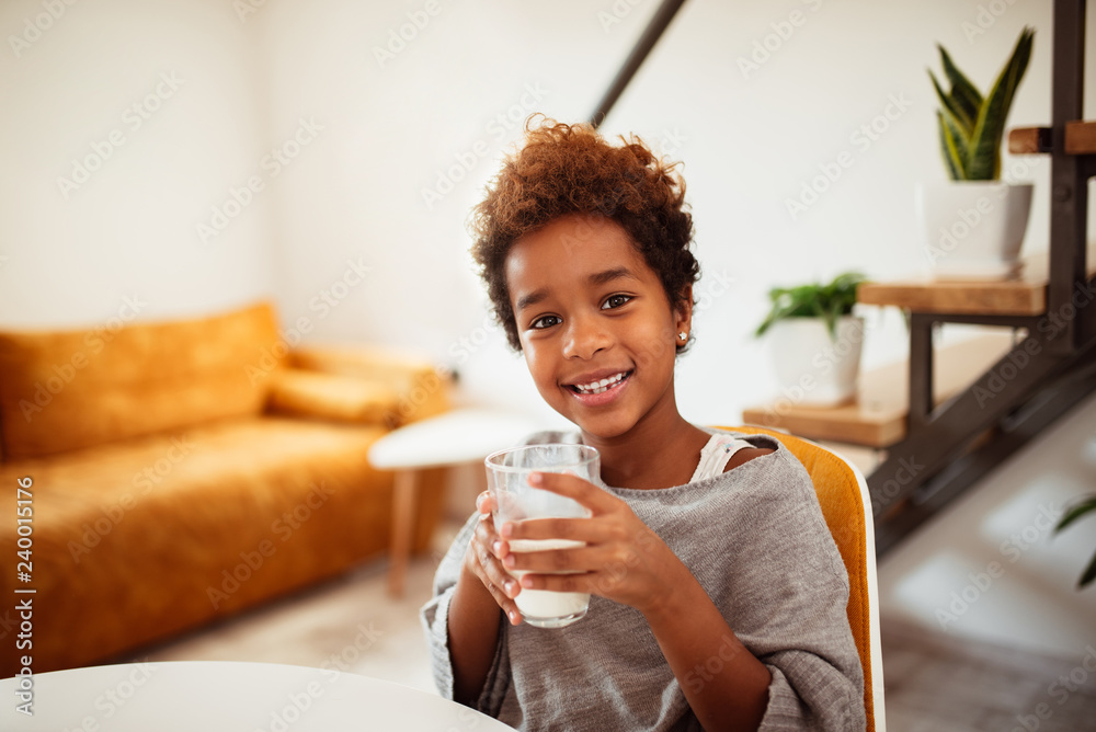 Gorgeous little girl drinking a glass of milk. Gorgeous little girl drinking a glass of milk.