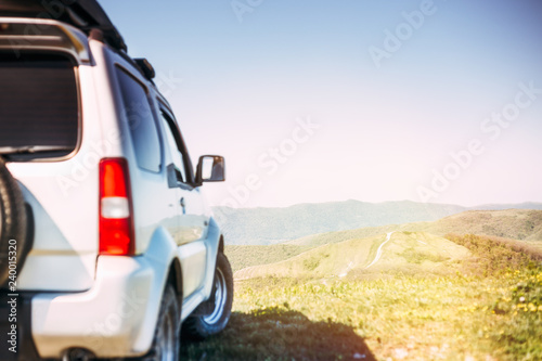 SUV car in mountains on clear sunny day