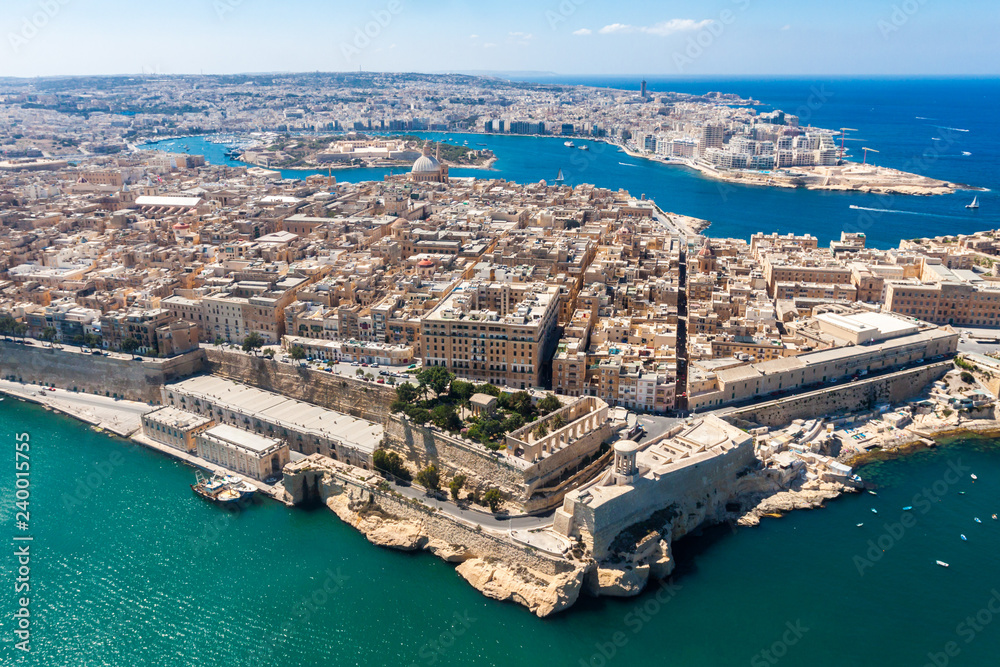 Historical Valetta, capital city of Malta, Grand harbour, Gzira and Sliema towns, Manoel Island in Marsamxett bay from above. Skyscraper in Paceville district is in the background. Malta aerial view.