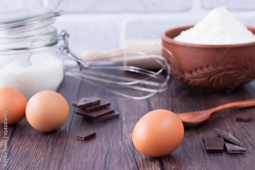 Products and objects for baking chocolate cake on dark wooden table. Concept of home baking. Products and objects for baking chocolate cake on dark wooden table. Concept of home baking.