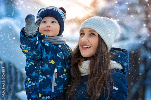 Woman and child in winter in nature. Portrait of a happy family